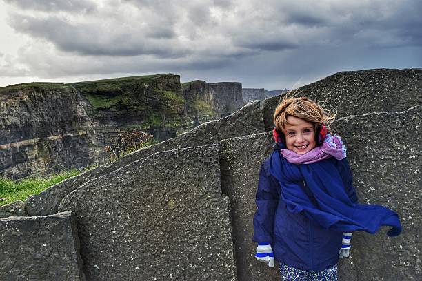 Little traveler Little girl bundled up while visiting the Cliffs of Moher in Ireland the burren photos stock pictures, royalty-free photos & images