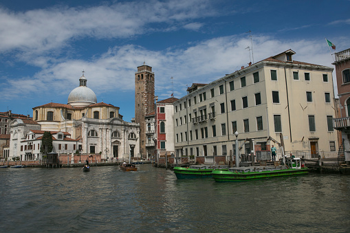 venice, italy - May 17, 2014: People are riding traditional gondolas at water channel of venice italy