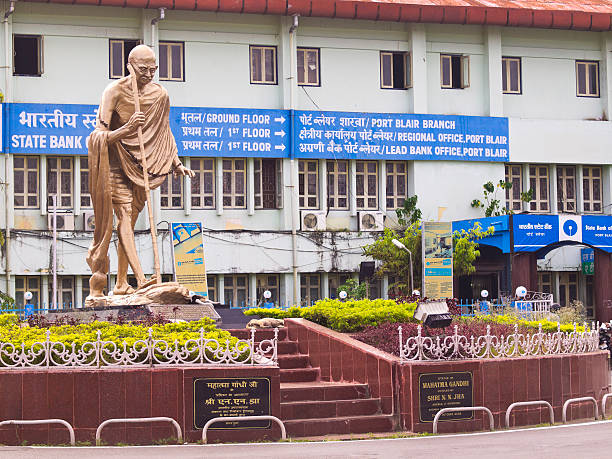 Port Blair Port Blair, India - December 28, 2013: Roundabout in Port Blair with the monument to Gandhi. In the background is a building with inscriptions: Regional administrative office and Bank and Port Blair. bay of bengal stock pictures, royalty-free photos & images
