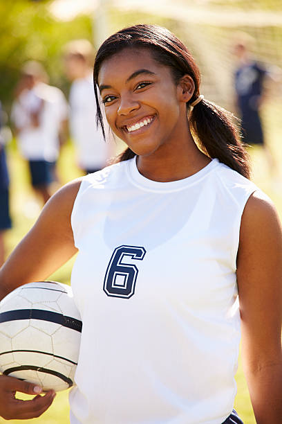 Portrait Of Player In Female High School Soccer Team Portrait Of Player In Female High School Soccer Team Smiling To Camera high school soccer stock pictures, royalty-free photos & images