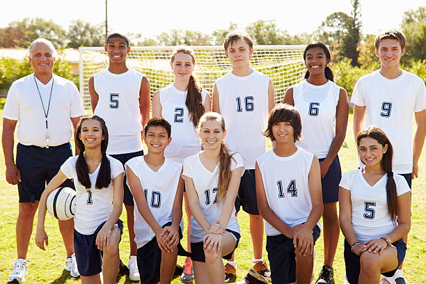 Portrait Of High School Soccer Team With Coach Portrait Of High School Soccer Team With Coach Smiling To Camera high school soccer stock pictures, royalty-free photos & images