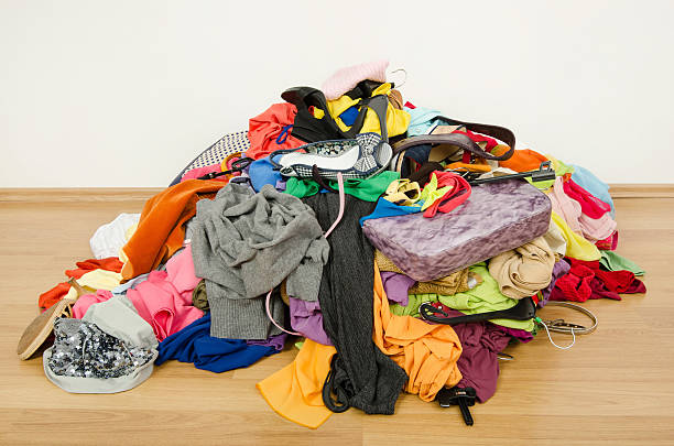 Big pile of clothes and accessories thrown on the ground. stock photo