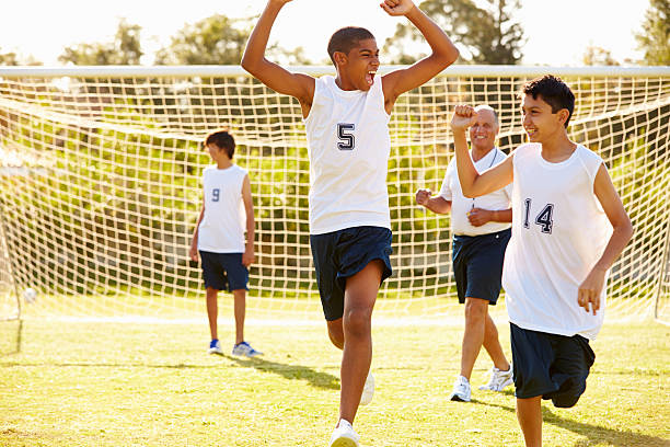 jugador de puntuación objetivo en high school partido de fútbol - marcar términos deportivos fotografías e imágenes de stock