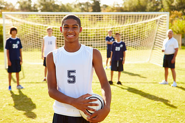 Portrait Of Player In High School Soccer Team Portrait Of Player In High School Soccer Team Holding Ball Smiling To Camera high school soccer stock pictures, royalty-free photos & images