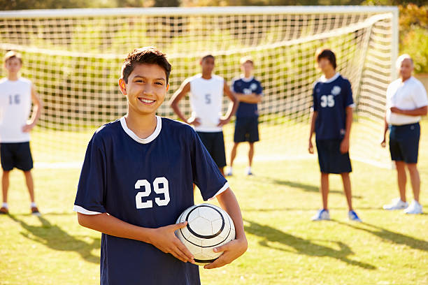 Portrait Of Player In High School Soccer Team Portrait Of Player In High School Soccer Team Holding Ball Smiling To Camera high school soccer stock pictures, royalty-free photos & images