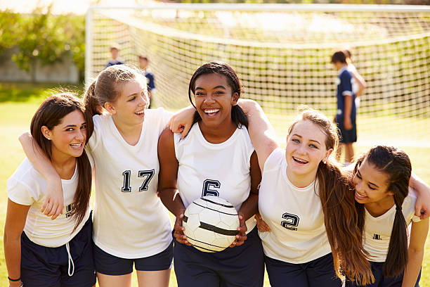 Members Of Female High School Soccer Team Members Of Female High School Soccer Team Smiling To Camera high school stock pictures, royalty-free photos & images