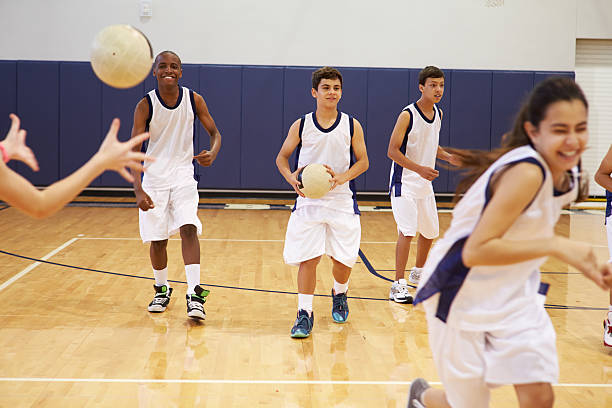 istock High School Students Playing Dodge Ball In Gym 498510325