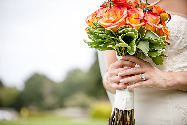 Wedding flowers in bride's hands stock photo