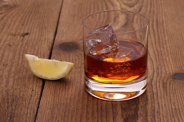istock Whiskey with ice cubes in glass on wood 498511077