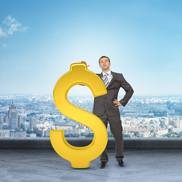 istock Businessman leaning on big dollar sign 498524146