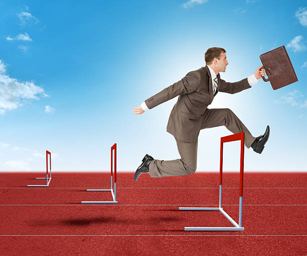 istock Businessman hopping over treadmill barrier 498524260