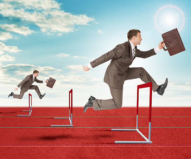 istock Businessmen hopping over treadmill barrier 498524302