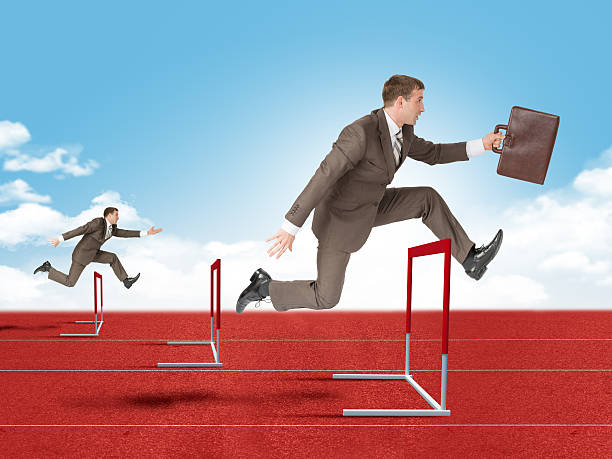istock Man hopping over red treadmill barrier 498525182