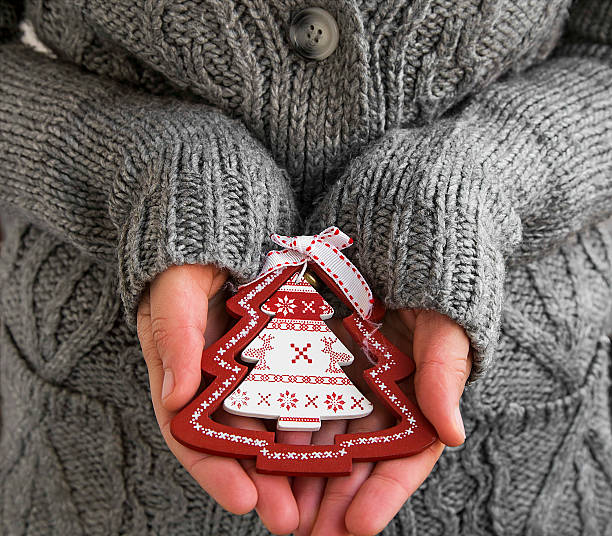 istock Female Hands Holding Christmas Tree Decoration 498525206