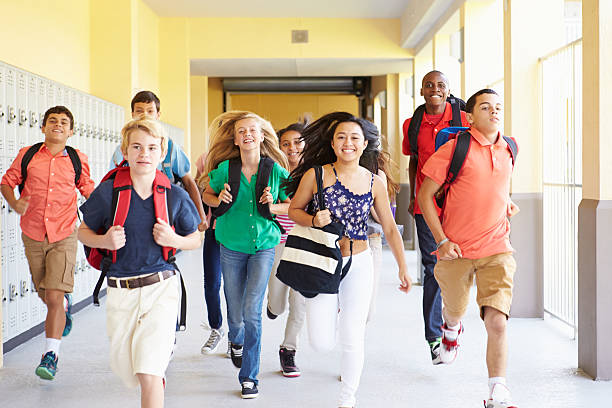 istock Group Of High School Students Running Along Corridor 498525219