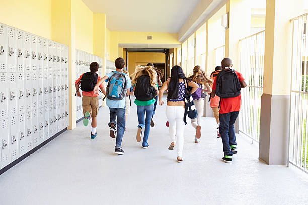 istock Group Of High School Students Running Along Corridor 498525273