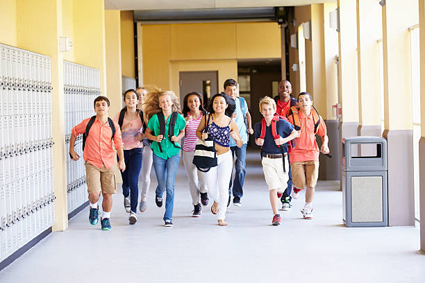 istock Group Of High School Students Running Along Corridor 498525293
