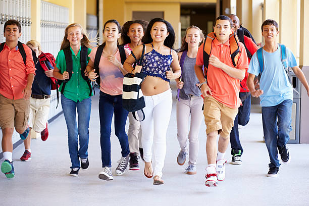 istock Group Of High School Students Running Along Corridor 498525337