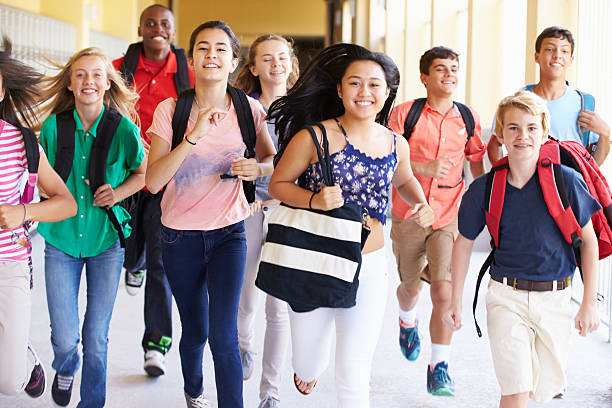 istock Happy high school students running in hallway 498525355
