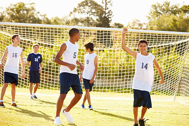 istock Player Scoring Goal In High School Soccer Match 498525761
