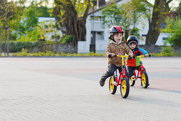 istock Two little siblings riding bikes in city on vacations 498526031
