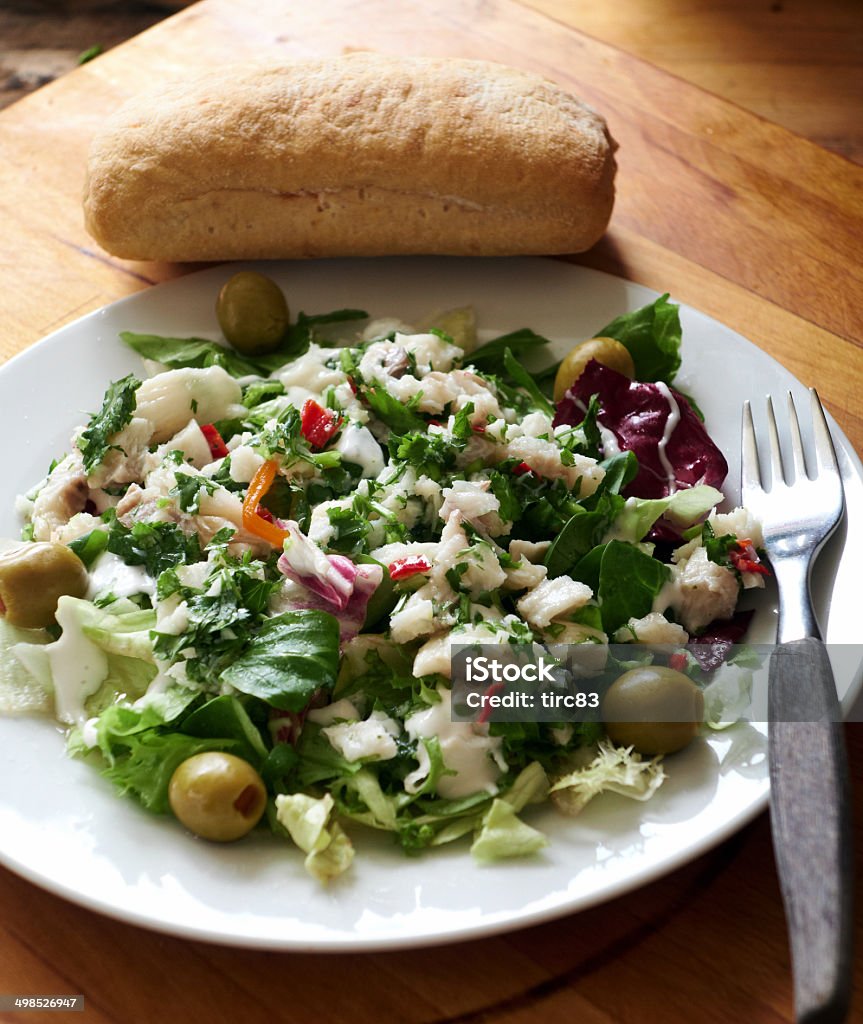 Ceviche raw fish dish of Peru Raw fish marinated in chillies and lemon juice and served with green olives. A side dish of green salad is on the plate. Ceviche is a national dish of Peru Bread Stock Photo