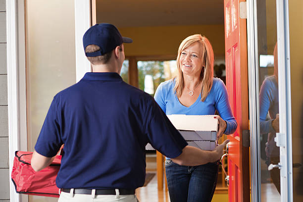 istock Take-out Pizza Delivery Man at Customer's Door 498527404