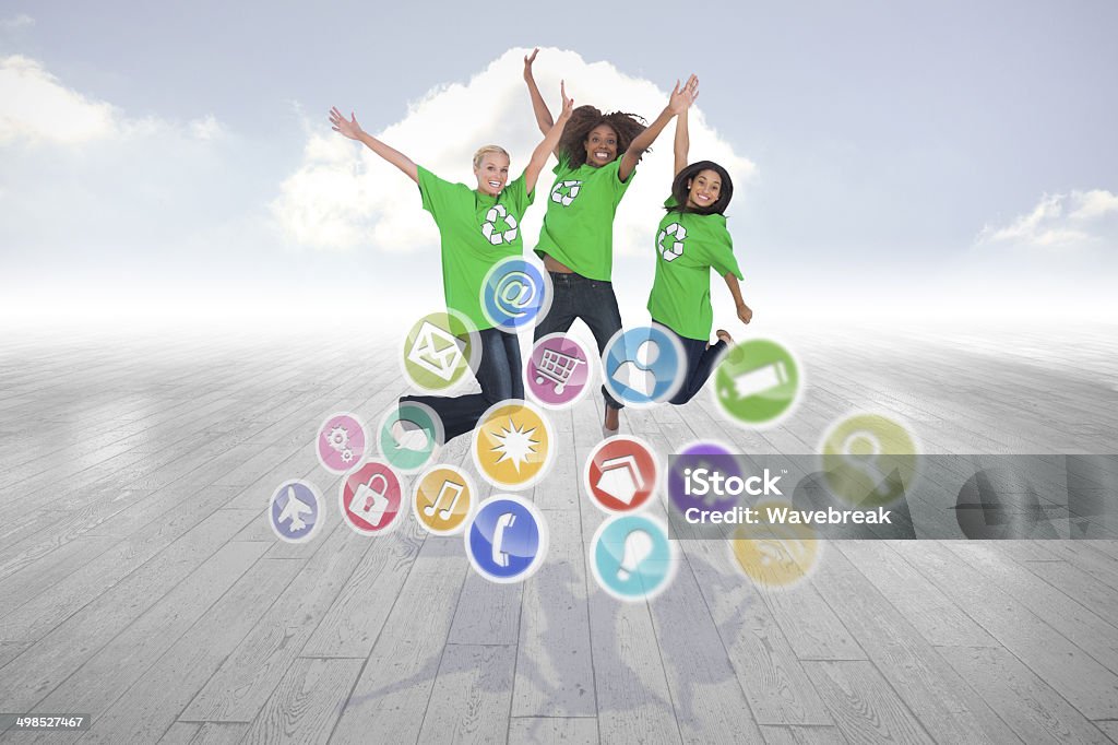 Composite image of enviromental activists jumping and smiling Enviromental activists jumping and smiling against cloudy sky background 20-29 Years Stock Photo
