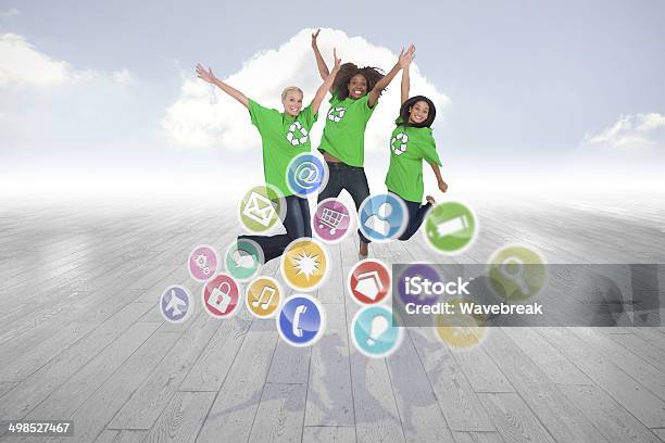 Composite Image Of Enviromental Activists Jumping And Smiling Stock Photo - Download Image Now