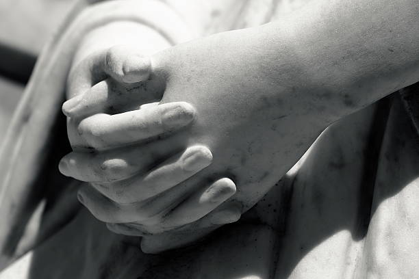 Detail of marble Virgin Mary praying hands Detail of marble Virgin Mary praying hands statue in a public cemetery of Southern Brazil. sistine madonna stock pictures, royalty-free photos & images
