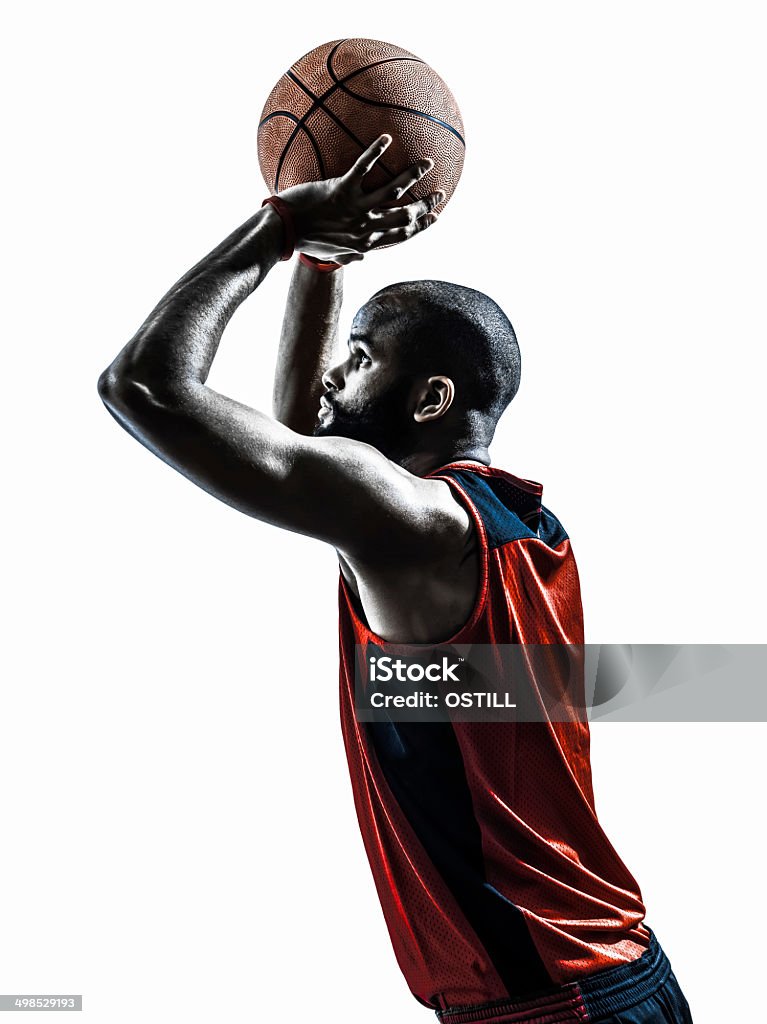 african man basketball player free throw silhouette one african man basketball player free throw in silhouette isolated white background Basketball Player Stock Photo