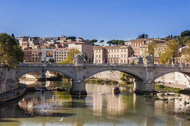 One of the several old bridges over the River Tiber or Tevere as it is known in Italian. There are several old bridges over the River Tiber in the City of Rome - some even dating back to early Roman times. Photo shows one of the bridges from the Renaissance period.  Photo shot in the afternoon sunlight; horizontal format. Copy space.