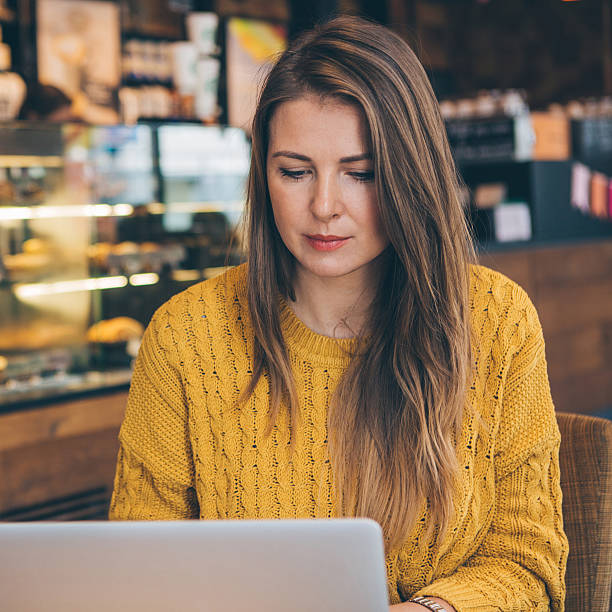 istock Woman with laptop at cafe. 498529550