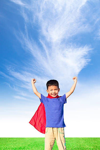 istock happy little boy imitate superhero and open arms 498529823