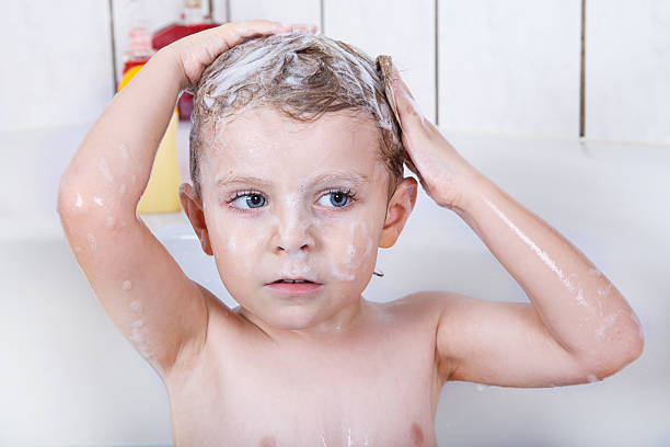 istock Cute little toddler boy washing hairs during bath 498530921