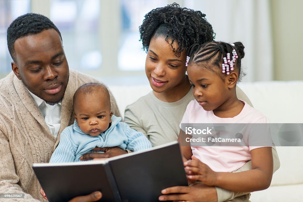 Story telling African American Family reading together Book Stock Photo