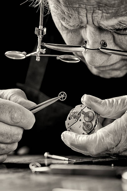 istock Watchmaker with magnifying lenses repairing a watch 498531835
