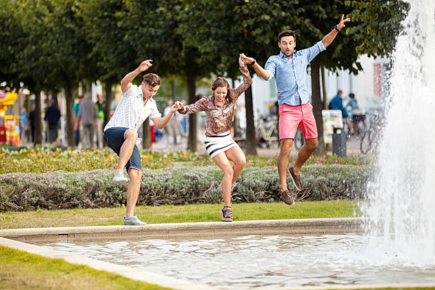 istock Friends Jumping Into Fountain 498532331