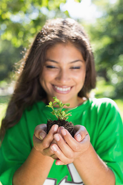 istock Environmental activist holding tiny shrub in the park 498532635