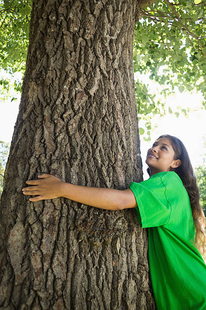 istock Environmental activist hugging a tree in the park 498532707