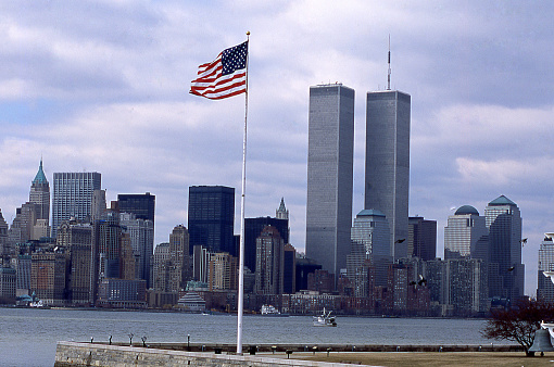 Twin Towers in Manhattan New York City and flag on Liberty Island New York