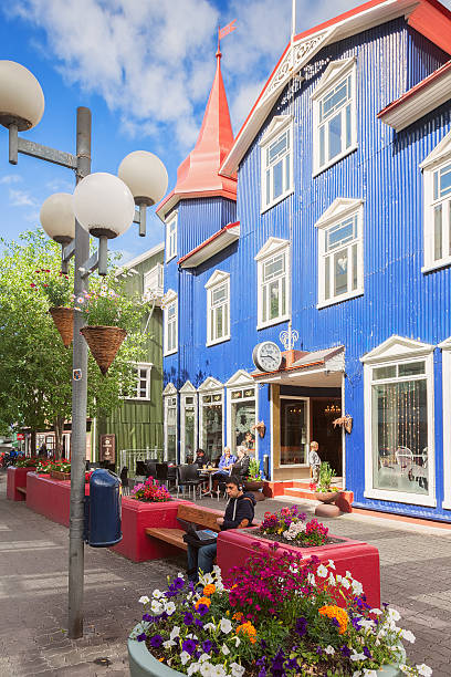Pedestrian street in the center of Akureyri, Iceland Akureyri, Iceland - June 22, 2014: Pedestrian street in the center of Akureyri. It is small city in northern Iceland, an important port and fishing center akureyri stock pictures, royalty-free photos & images