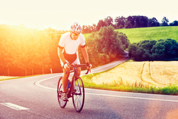 istock Sun shines on athlete who rides his bicycle up hill 498534456