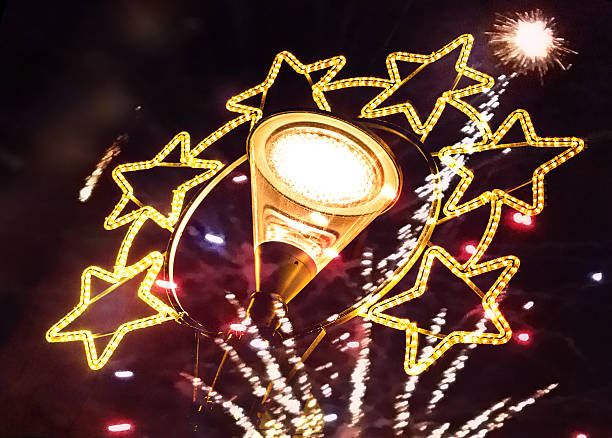 istock Christmas decorated street lantern with Fireworks 498534982