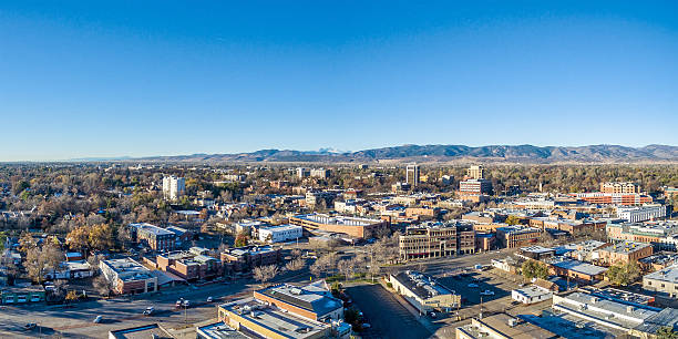 Fort Collins cityscape panorama Fort Collins downtown aerial panorama,  fall  scenery od Colorado with Front Range of Rocky Mountains in background front range mountain range stock pictures, royalty-free photos & images