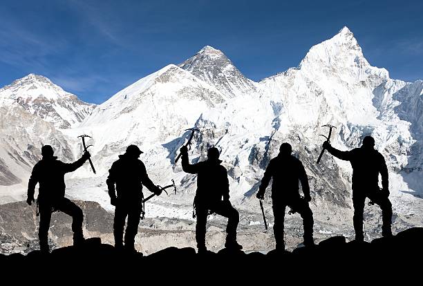 istock Mount Everest and silhouette of climbing men 498537116