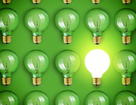 Concept for big idea. Light bulbs on green