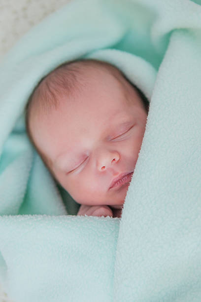 istock Caucasian newborn baby while sleeping closeup 498548138