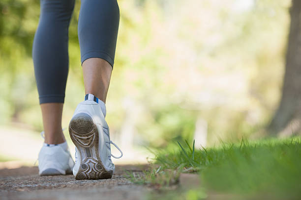 istock Woman walking along a pathway in the park 498548971