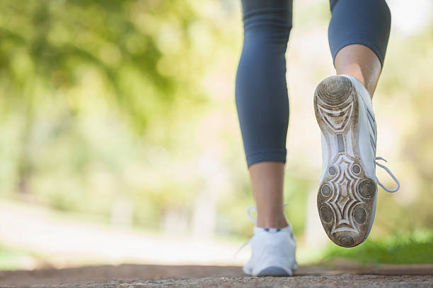 istock Jogger running along a pathway in the park 498548973